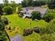 An aerial view showcases a backyard featuring an expansive lawn and diverse landscaping elements at 3619 Nc-57, Hillsborough, NC 27278