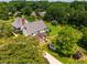Charming home with lush landscaping, wooden pergola, shed and expansive yard surrounded by mature trees at 3619 Nc-57, Hillsborough, NC 27278
