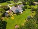 Aerial view shows the house, long driveway, and huge backyard space with lush landscaping at 3619 Nc-57, Hillsborough, NC 27278