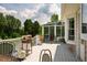 Wide back deck features space for outdoor dining, grill, and access to the sunroom at 3619 Nc-57, Hillsborough, NC 27278