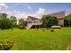 A lush backyard features a spacious lawn, a deck, and manicured gardens, perfect for outdoor enjoyment at 3619 Nc-57, Hillsborough, NC 27278