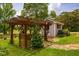 Landscaped backyard with a pergola and shed, creating a tranquil outdoor retreat at 3619 Nc-57, Hillsborough, NC 27278