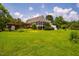 Well-maintained backyard with lush lawn, pergola, and the house on the background at 3619 Nc-57, Hillsborough, NC 27278