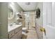 Cozy bathroom with tile floors, glass shower door, sink with modern fixtures and wall decorations at 3619 Nc-57, Hillsborough, NC 27278