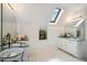 Bright bathroom featuring skylight, double sink and decorative fixtures at 3619 Nc-57, Hillsborough, NC 27278