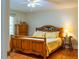 Bedroom featuring hardwood floors, wooden furniture, and a well-lit atmosphere at 3619 Nc-57, Hillsborough, NC 27278