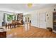 Spacious dining area featuring wood floors, ample natural light, and seamless access to outdoors at 3619 Nc-57, Hillsborough, NC 27278