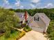 Well-maintained home exterior featuring a brick chimney, a two-car garage, and manicured landscaping at 3619 Nc-57, Hillsborough, NC 27278