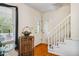 Well lit Foyer with hardwood floors, white trim, with a large window and stairs to the second floor at 3619 Nc-57, Hillsborough, NC 27278
