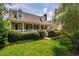 Inviting home featuring a charming front porch, manicured lawn, and beautifully landscaped shrubbery at 3619 Nc-57, Hillsborough, NC 27278