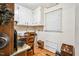 Cozy kitchen nook area with wooden desk, chair, and storage space at 3619 Nc-57, Hillsborough, NC 27278