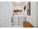 Bright laundry room featuring white appliances and decoratively organized shelving at 3619 Nc-57, Hillsborough, NC 27278