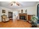 Charming living room with hardwood flooring, a brick fireplace, and ample natural light at 3619 Nc-57, Hillsborough, NC 27278