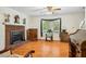 Bright living room featuring hardwood floors, brick fireplace and large window allowing ample natural light at 3619 Nc-57, Hillsborough, NC 27278