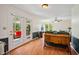 Inviting living room with a sunroom visible through French doors, natural light, and a vintage cabinet at 3619 Nc-57, Hillsborough, NC 27278