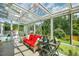 Spacious sunroom with scenic views, cozy seating, and a tranquil atmosphere at 3619 Nc-57, Hillsborough, NC 27278
