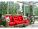 Inviting sunroom with comfortable wicker furniture and serene views of lush greenery at 3619 Nc-57, Hillsborough, NC 27278