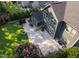 Aerial view of a backyard with well-maintained garden, green lawn, and stamped concrete patio with fire pit at 3624 Regent Pines Dr, New Hill, NC 27562