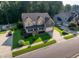 Stunning aerial view of a home with manicured lawn, lush landscaping, and a spacious driveway at 3624 Regent Pines Dr, New Hill, NC 27562