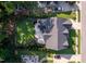Aerial view of the property, featuring a green lawn, patio, pool, and meticulous landscaping at 3624 Regent Pines Dr, New Hill, NC 27562