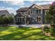 Spacious backyard with a lush lawn, patio, and well-manicured landscaping at 3624 Regent Pines Dr, New Hill, NC 27562