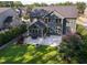 Gorgeous aerial view of a backyard featuring a patio, fire pit, lush greenery, and beautifully landscaped areas at 3624 Regent Pines Dr, New Hill, NC 27562