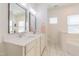 Elegant bathroom with double vanities, marble floors, and plenty of natural light at 3624 Regent Pines Dr, New Hill, NC 27562