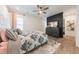 Comfortable bedroom with a decorative accent wall, ceiling fan, and plenty of natural light at 3624 Regent Pines Dr, New Hill, NC 27562