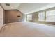 Spacious bonus room with multiple windows offering natural light and a vaulted ceiling at 3624 Regent Pines Dr, New Hill, NC 27562