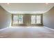 Light filled bonus room featuring neutral walls, carpet and multiple windows offering natural light at 3624 Regent Pines Dr, New Hill, NC 27562
