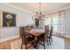 Cozy dining room with hardwood floors, soft lighting, and a window for a comfortable dining experience at 3624 Regent Pines Dr, New Hill, NC 27562