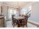 Bright dining room with hardwood floors, a modern chandelier, and ample natural light for Gathering meals at 3624 Regent Pines Dr, New Hill, NC 27562
