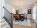 Elegant dining room with hardwood floors, stylish chandelier, and large table for hosting gatherings at 3624 Regent Pines Dr, New Hill, NC 27562