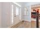 Bright entryway with decorative front door, hardwood floors, and light walls leading into the rest of the home at 3624 Regent Pines Dr, New Hill, NC 27562