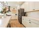 Modern kitchen featuring stainless appliances, white cabinets, stone countertops and floating shelves at 3624 Regent Pines Dr, New Hill, NC 27562