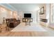 Cozy living room featuring a modern fireplace, lots of natural light and comfortable seating at 3624 Regent Pines Dr, New Hill, NC 27562