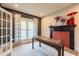 Home office with large window, fireplace, and hardwood floors, creating a stylish and functional workspace at 3624 Regent Pines Dr, New Hill, NC 27562