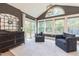 Cozy sun room featuring lots of natural light, black accent wall and comfortable seating at 3624 Regent Pines Dr, New Hill, NC 27562