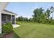 Spacious backyard with a screened porch, lush green lawn, and mature trees at 365 Middleton Pl, Chapel Hill, NC 27516