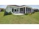Landscaped backyard featuring a screened porch, patio with furniture and manicured lawn at 365 Middleton Pl, Chapel Hill, NC 27516