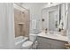 Well-lit bathroom with a tub, shower featuring tiled walls, white toilet, and a sink with vanity at 365 Middleton Pl, Chapel Hill, NC 27516