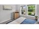 Bright bedroom featuring a wooden dresser, natural light from double windows and calming wall art at 365 Middleton Pl, Chapel Hill, NC 27516