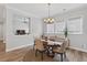Dining room with wood table, soft gray chairs, modern lighting, and large windows at 365 Middleton Pl, Chapel Hill, NC 27516