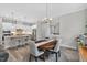 Dining room featuring a wood table, gray chairs, pendant lighting, and views into an open kitchen at 365 Middleton Pl, Chapel Hill, NC 27516