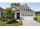 Charming one-story home featuring a manicured lawn, stone accents, and a two-car garage at 365 Middleton Pl, Chapel Hill, NC 27516