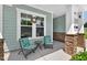 Cozy front porch with stone pillars, seating, and a decorative wreath at 365 Middleton Pl, Chapel Hill, NC 27516