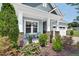 Inviting front porch enhanced by stone supports, attractive seating, and lush landscaping at 365 Middleton Pl, Chapel Hill, NC 27516