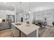 Open kitchen featuring stainless steel appliances, a large island with a quartz countertop, and pendant lighting at 365 Middleton Pl, Chapel Hill, NC 27516