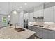 Beautiful kitchen featuring a large island, modern lighting, and stainless steel appliances at 365 Middleton Pl, Chapel Hill, NC 27516