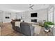 Open living room with wood flooring, modern fireplace, TV, and a view to the dining area at 365 Middleton Pl, Chapel Hill, NC 27516